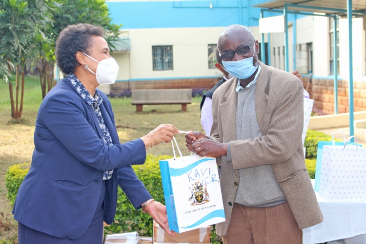 CHS Deputy Principal Prof. Evelyn Wagaiyu hands over a gift package to KAVI Director Prof.  Walter Jaoko.