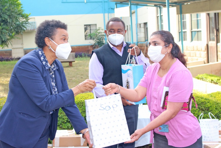 CHS Deputy Principal Prof. Evelyn Wagaiyu hands over a gift package to Department of Pharmaceutics and Pharmacy Practice Chair, Dr. Shital Maru.