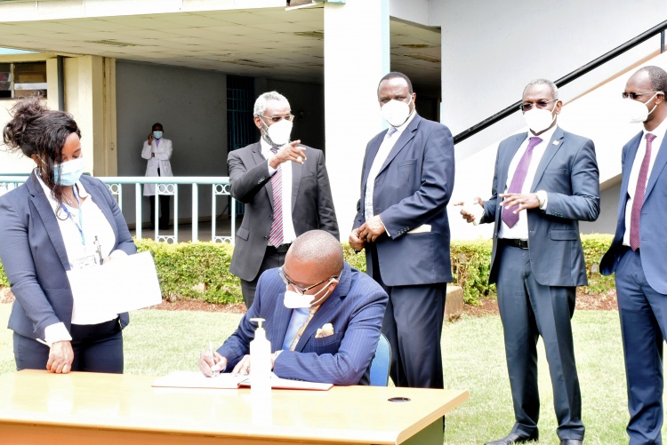 Equity Group Chief Commercial Officer, Polycarp Igathe signs visitors book at CHS.