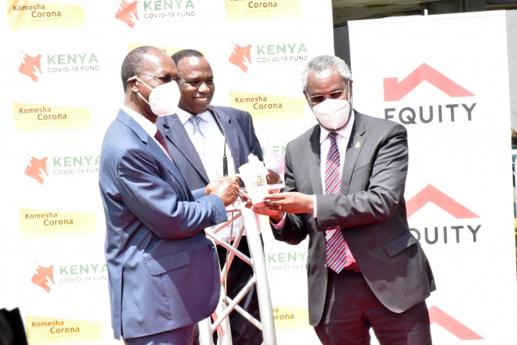 UoN Vice Chancellor Prof. Stephen Kiama gifts Prof. Isaac Macharia, Equity Group Chairman.