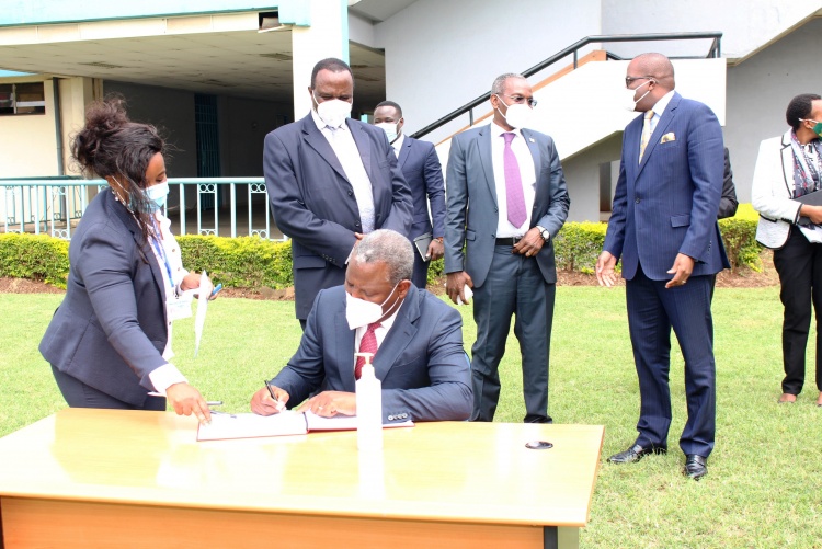 Dr James Mwangi Equity Group Managing Director and CEO signs visitors book.