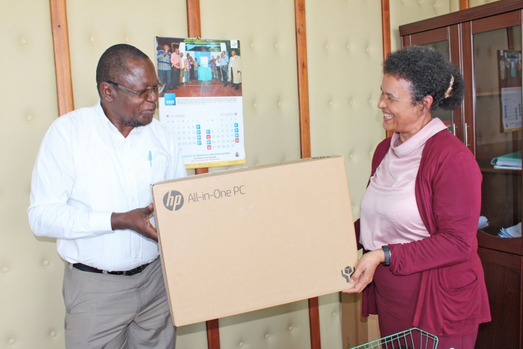     Prof. Julius Oyugi, Director Research, UNITID hands over computer donation to Prof. Evelyn Wagaiyu, Associate Dean Postgraduate.