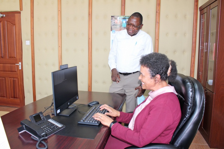     Prof. Julius Oyugi, Director Research, UNITID hands over computer donation to Prof. Evelyn Wagaiyu, Associate Dean Postgraduate.
