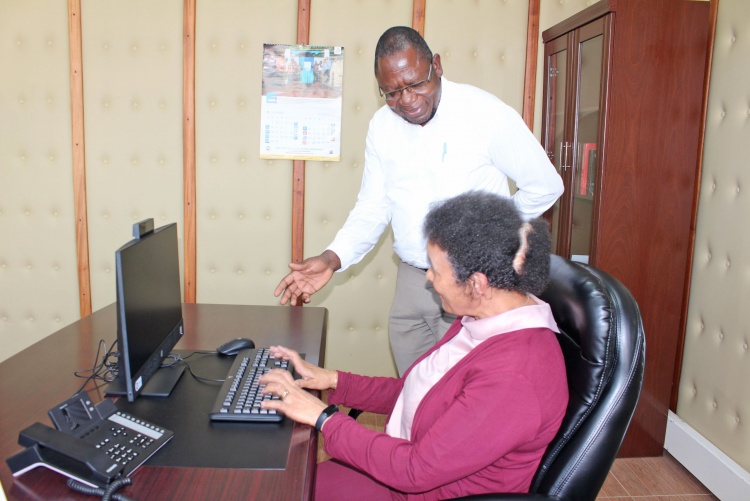     Prof. Julius Oyugi, Director Research, UNITID hands over computer donation to Prof. Evelyn Wagaiyu, Associate Dean Postgraduate.