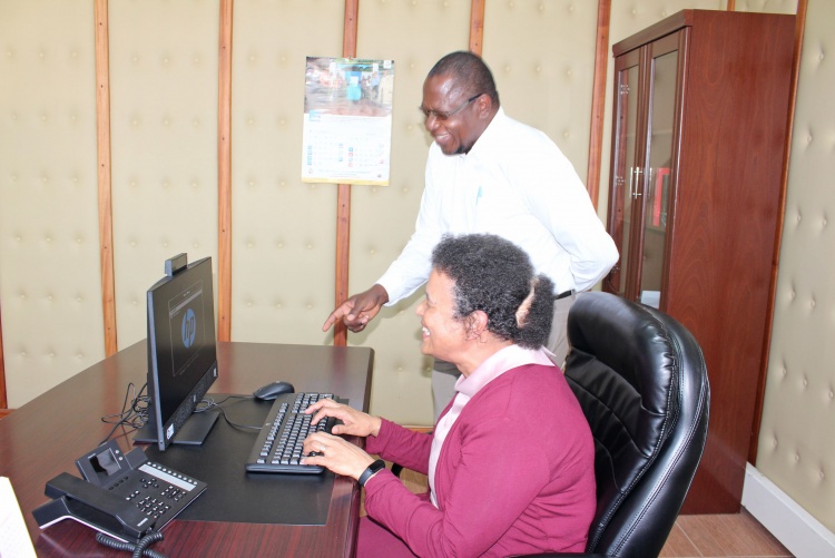     Prof. Julius Oyugi, Director Research, UNITID hands over computer donation to Prof. Evelyn Wagaiyu, Associate Dean Postgraduate.