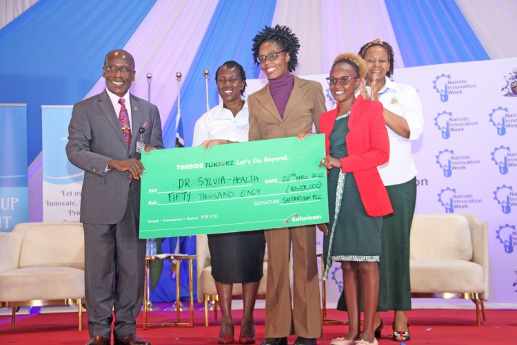 Prof. Julius Ogeng'o, Deputy Vice Chancellor Academic Affairs awards Dr. Sylvia Opanga for emerging top during the Nairobi Innovation Week 2022.