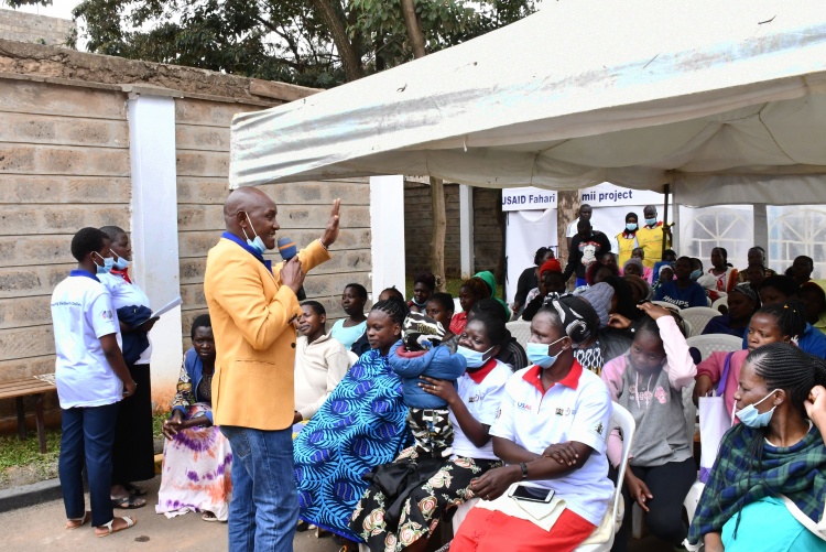 A clinician welcoming the mothers the maternal day event. 