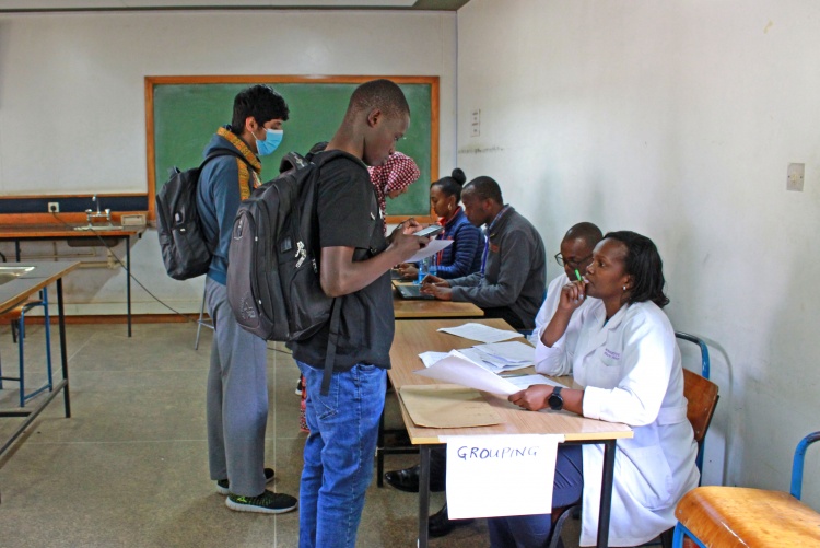 Student registering for group discussions.