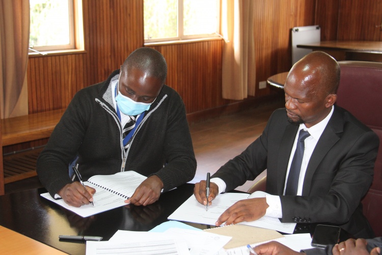 Faculty of Health Sciences Dean Prof. George Osanjo(R) with Dr. Eric Guantai, Chair Department of Pharmacy during the signing of the 2022/2023 performance contract.