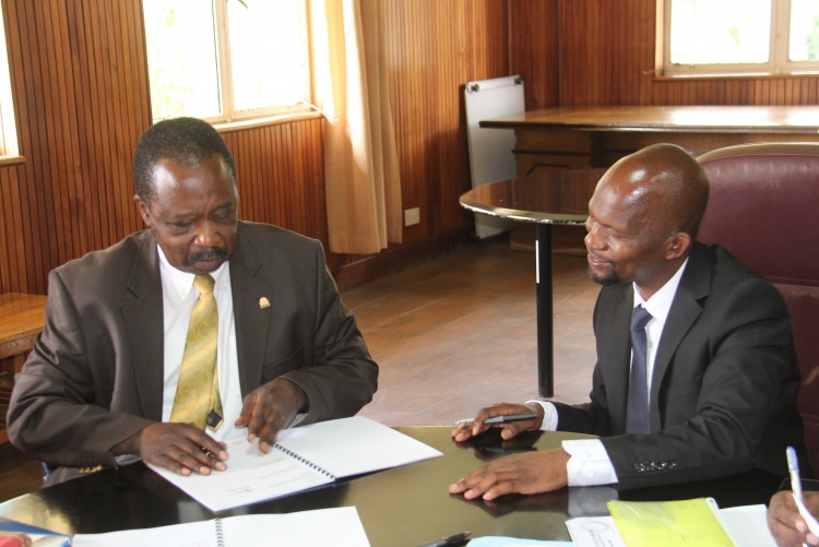 Faculty of Health Sciences Dean Prof. George Osanjo(R) with Prof. Erastus Amayo, Chair Department of Clinical Medicine during the signing of the 2022/2023 performance contract.