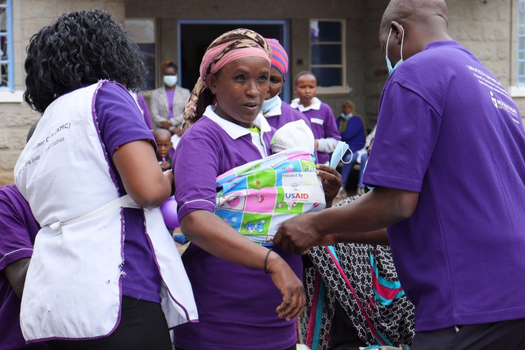 Community health volunteers demonstrating Kangaroo Mother Care during  World Prematurity day commemoration.